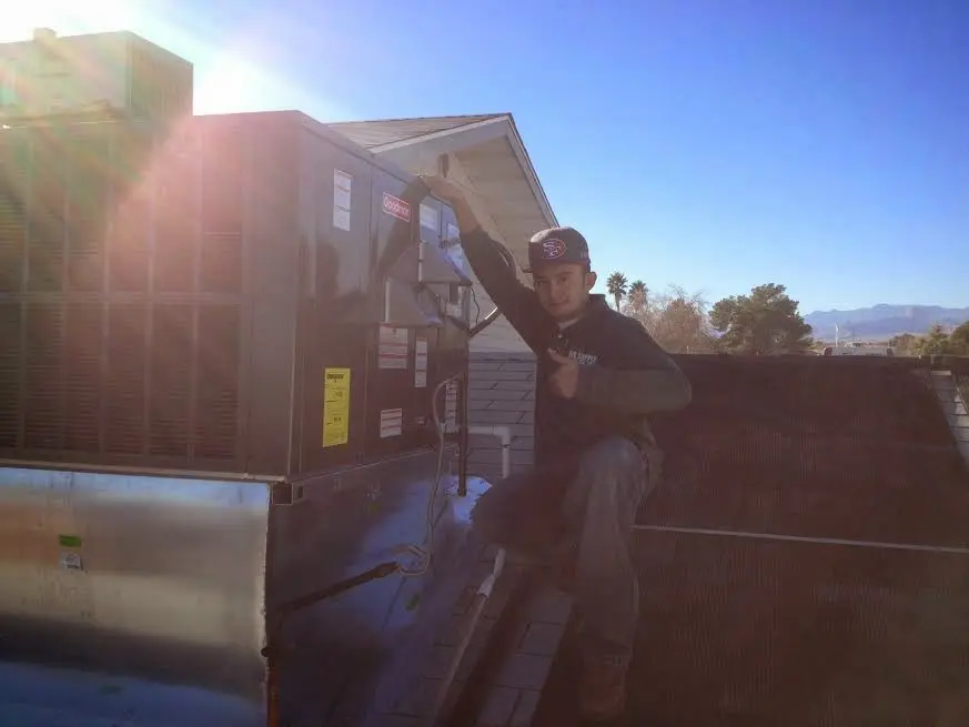 HVAC technician performing HVAC Inspection on a rooftop unit in Eureka
